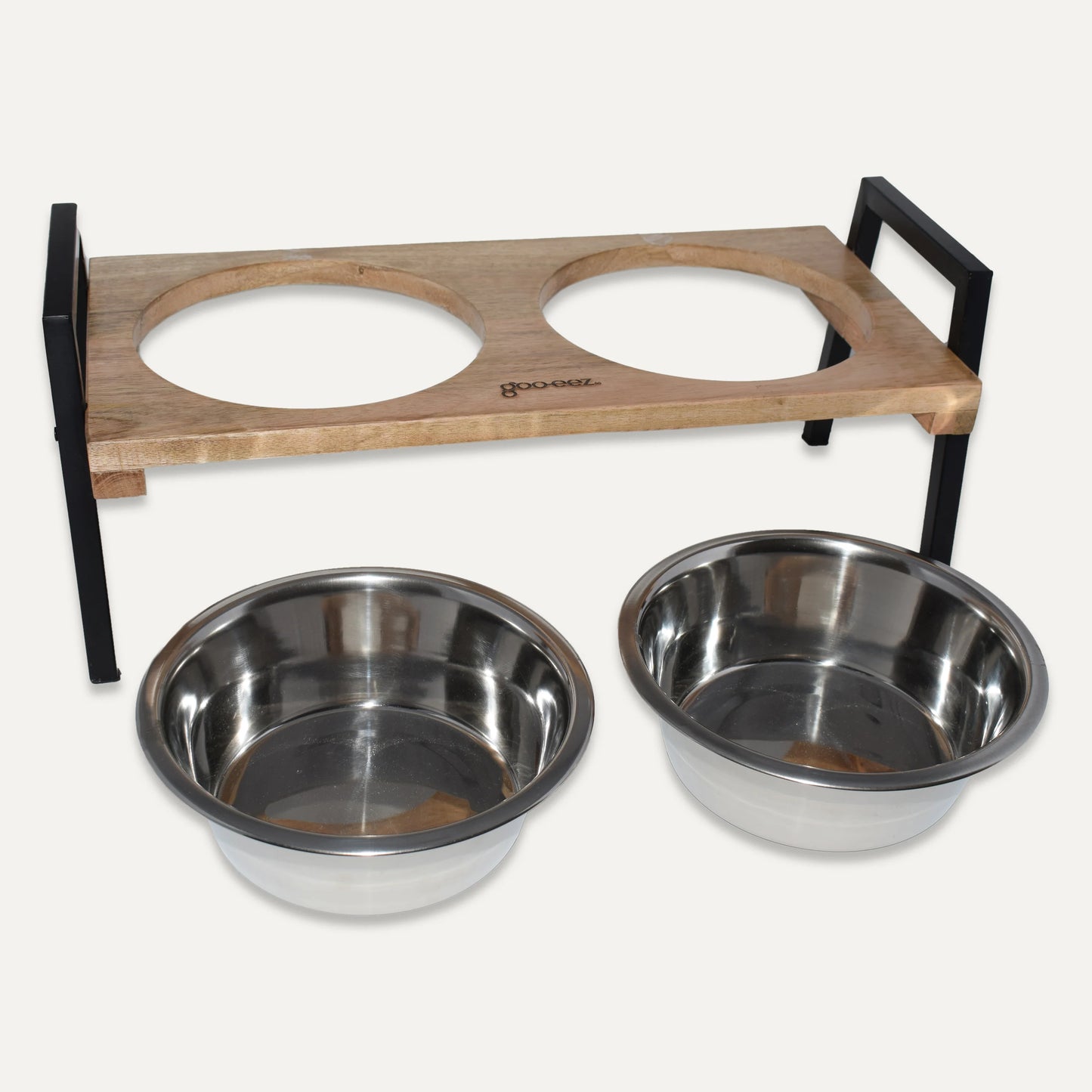 Wooden pet feeder with two metal bowls on a white background