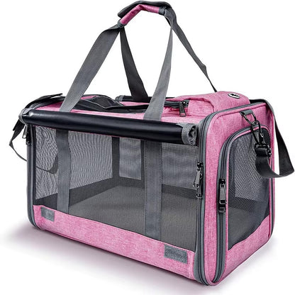 Pink pet carrier with black mesh sides and straps on a white background