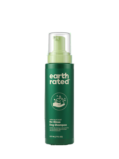 Green bottle of earth rated no-rinse dog shampoo on a white background