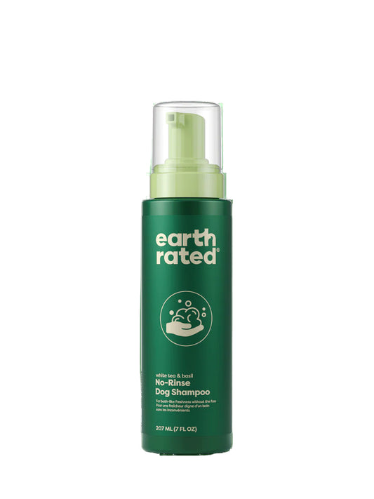 Green bottle of earth rated no-rinse dog shampoo on a white background