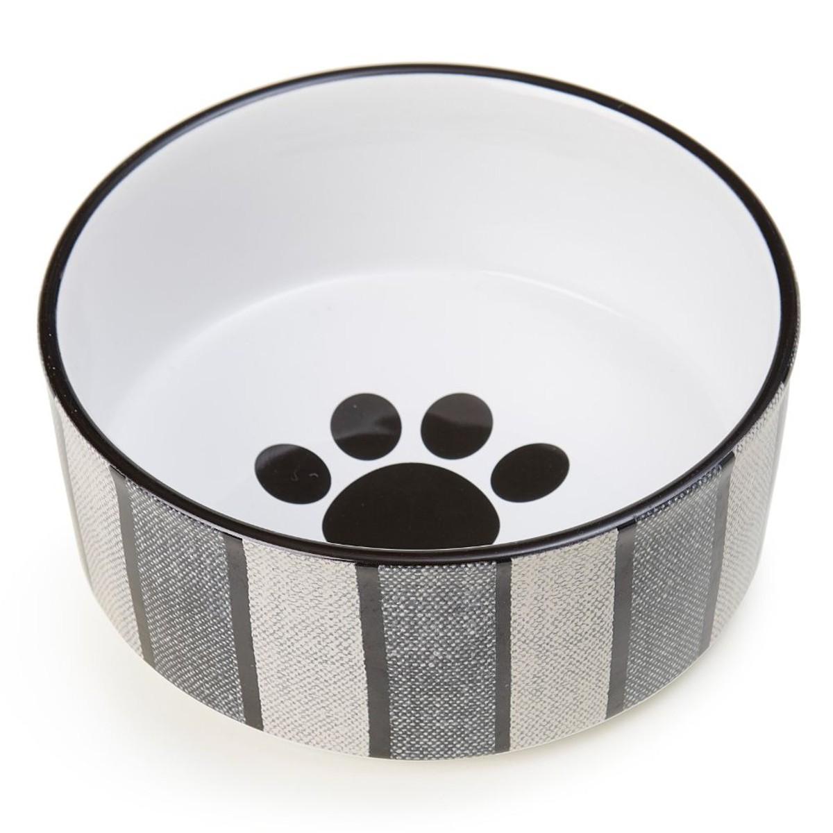 Pet bowl with a black paw print design on a white background