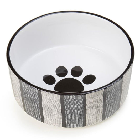 Pet bowl with a black paw print design on a white background
